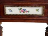 a small wooden table with a floral design on it