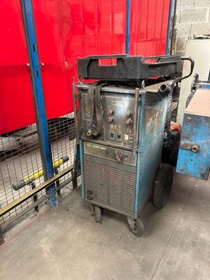 une machine posée au sol devant un mur rouge