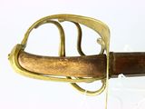 a close up of a sword with a wooden handle
