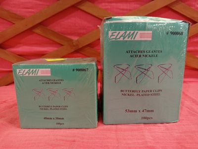 two boxes of mail sitting on top of a pink table cloth