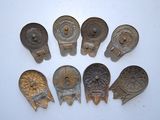 several antique metal spoons and spoon spoons on a white surface