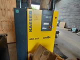 a machine that is sitting in a warehouse next to a pile of boxes