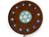 a wooden clock with a blue and white design on it