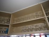 many glasses on the shelves in the kitchen