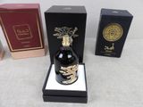 a bottle of perfume sitting on top of a table next to a box