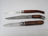three different types of knives are on a white surface