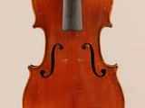 an old violin with a bow hanging from it ' s back