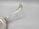 a close up of a spoon with a handle on a white surface