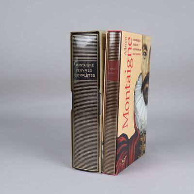 two books are stacked on top of each other on a table