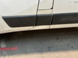 a white van parked in a parking lot next to a red fire hydrant