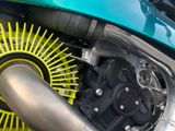 a close up of a motorcycle engine with a yellow spoke
