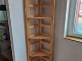 a corner shelf in the corner of a room