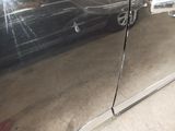 a reflection of a car on the side of the door