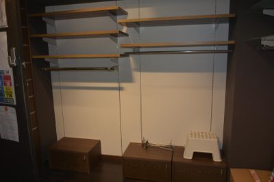 a closet with shelves and drawers in a room