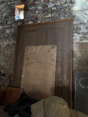 a room with a door, a window, and a chair in it