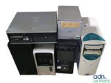 a lot of computers and a printer sitting on top of each other