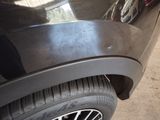 a close up of a car ' s tire on the side of the road