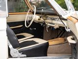 a white car with black leather seats and a steering wheel