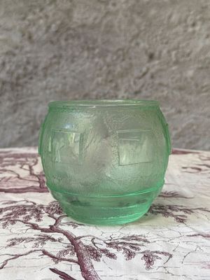 a small green glass bowl sitting on a table