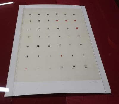 a sheet of paper on a table with a red table cloth
