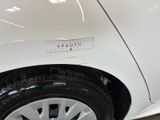 a close up of a white car with a sticker on it