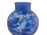 a blue vase that has a picture of a fish and flowers on it