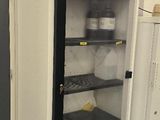 two refrigerators in a room with one open and the other closed