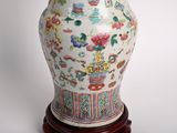 a vase that is sitting on a stand on a table