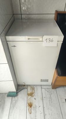 a broken refrigerator in the corner of a kitchen