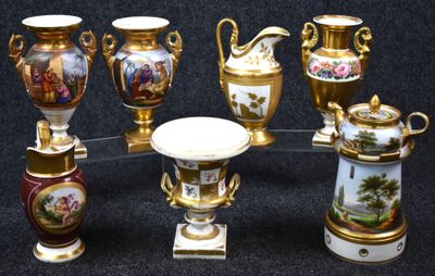 seven vases with different designs on them on a black background