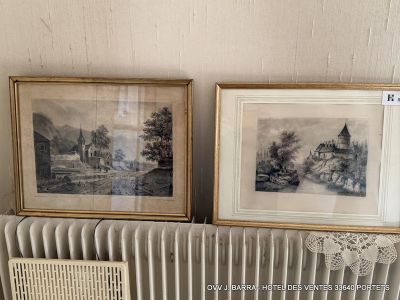 two framed pictures on a radiator next to a radiator