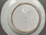a white plate with a brown rim on a table
