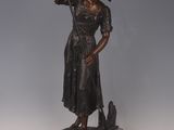 bronze statue of a woman holding a flag on a pedestal