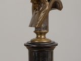 statue of a man with a crown of thorns on his head on a pedestal