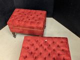 pair of red tufted foot stools on casteors