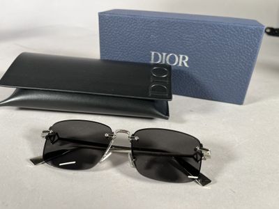christian dior sunglasses with box and case on table