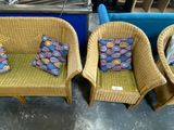three wicker chairs with cushions and a pillow on them in a store