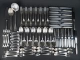 many spoons, forks, and spoon spoons laid out on a table