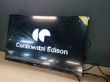 a flat screen television sitting on a desk with a mouse