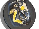 a black plate with a painting of an elephant on it