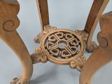 a small wooden table with carvings on the legs