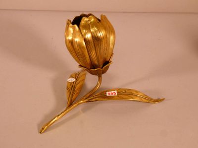a gold flower that is sitting on a table