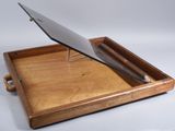 a wooden tray with a laptop on top of it