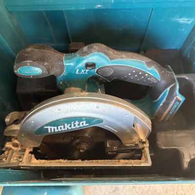 a close up of a corded circular saw in a blue box