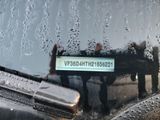 a sign on the windshield of a car in the rain