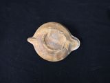 an image of a piece of pottery sitting on top of a black table