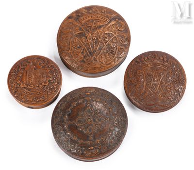 three small wooden buttons with ornate designs on them on a white surface