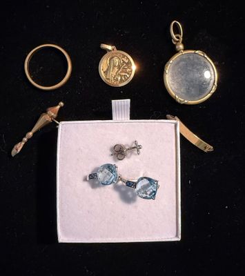 three pieces of jewelry are displayed in a box on a black surface
