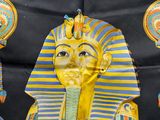 yellow and blue egyptian mask on a black background with other items