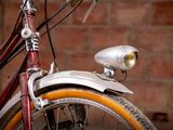 a close up of a bicycle with a light on it